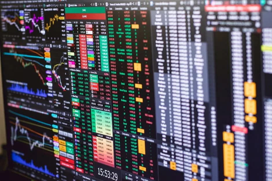 Multiple stock market trading screens showing price charts, representing the Robinhood Chain stock tokens that track real equity prices