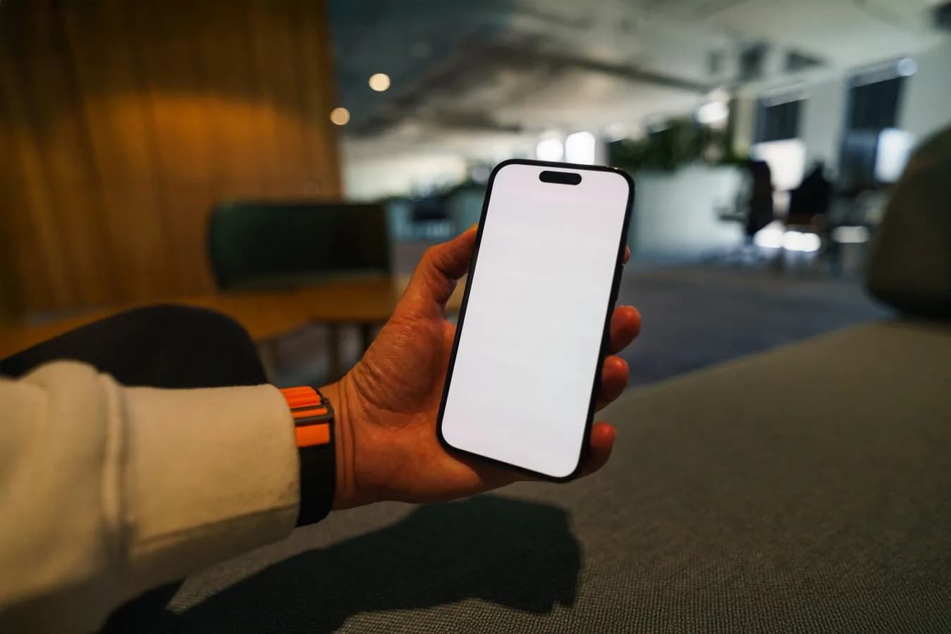 Hand holding a smartphone with a blank screen, ready for an app launch mockup. Photo by Jakub Zerdzicki on Pexels.