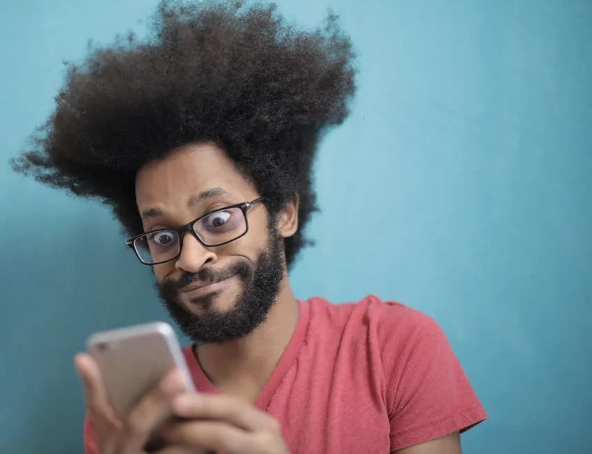 Excited person looking at a smartphone screen, the kind of reaction traders had watching Robinhood Chain memecoins surge in a single day. Photo by Andrea Piacquadio on Pexels.