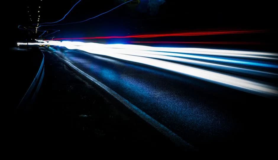Light trails in motion at night, representing the dramatic speedup in transaction finality Solana's Alpenglow upgrade is designed to deliver. Photo by Mateusz Dach on Pexels.