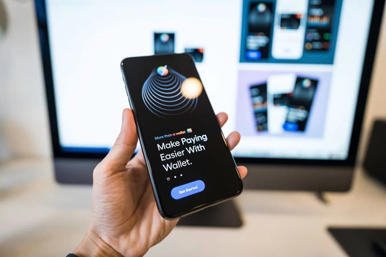 Close-up of a hand holding a smartphone showing a digital wallet app interface. Photo by Tranmautritam on Pexels.
