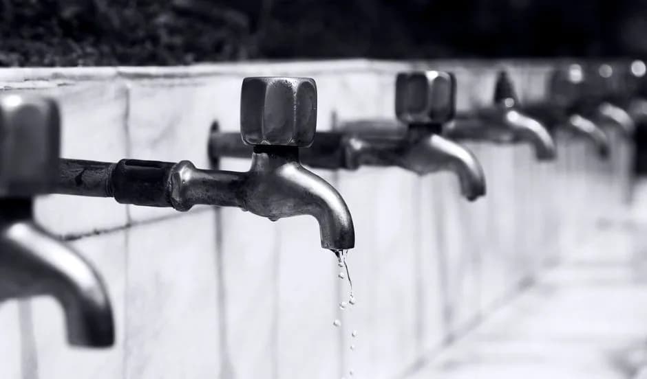 Close-up of a water faucet with a single droplet, representing the Robinhood Chain testnet faucet handing out free practice tokens. Photo by PS Photography on Pexels.