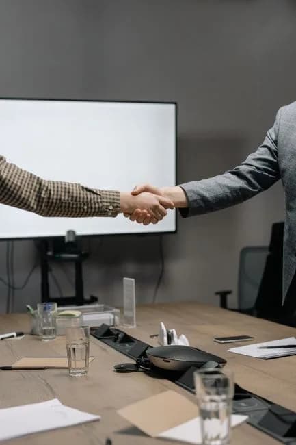 Two business professionals shaking hands representing CLARITY Act Senate negotiations