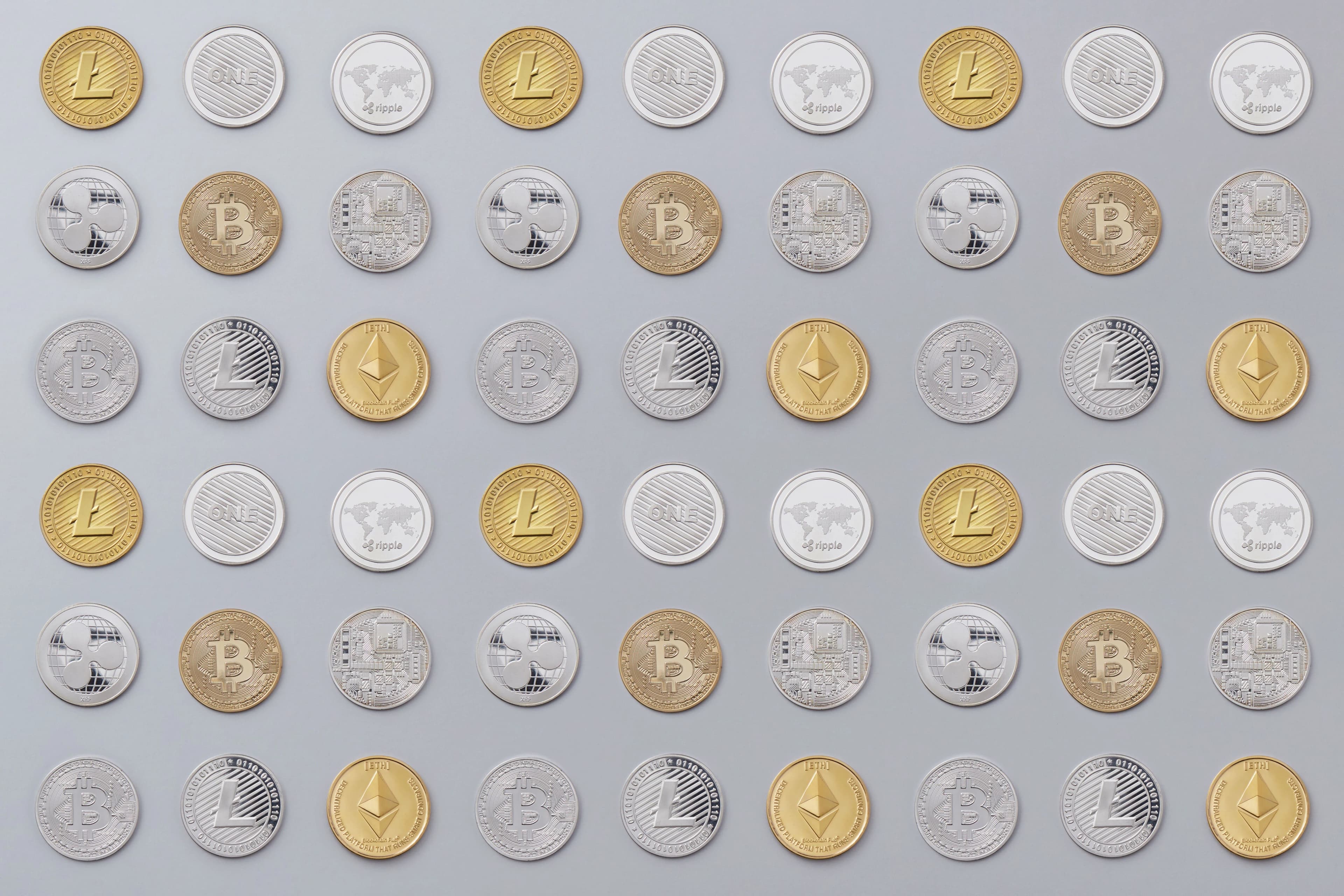 Cryptocurrency coins arranged on a neutral background, representing payment stablecoins covered under the GENIUS Act