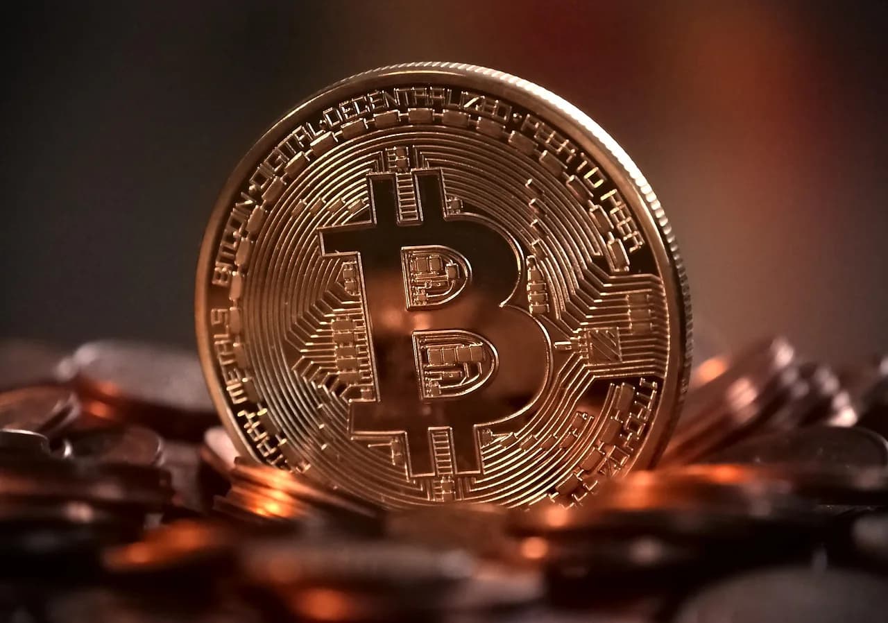 Cryptocurrency coins with a warning sign representing DeFi exploit risk